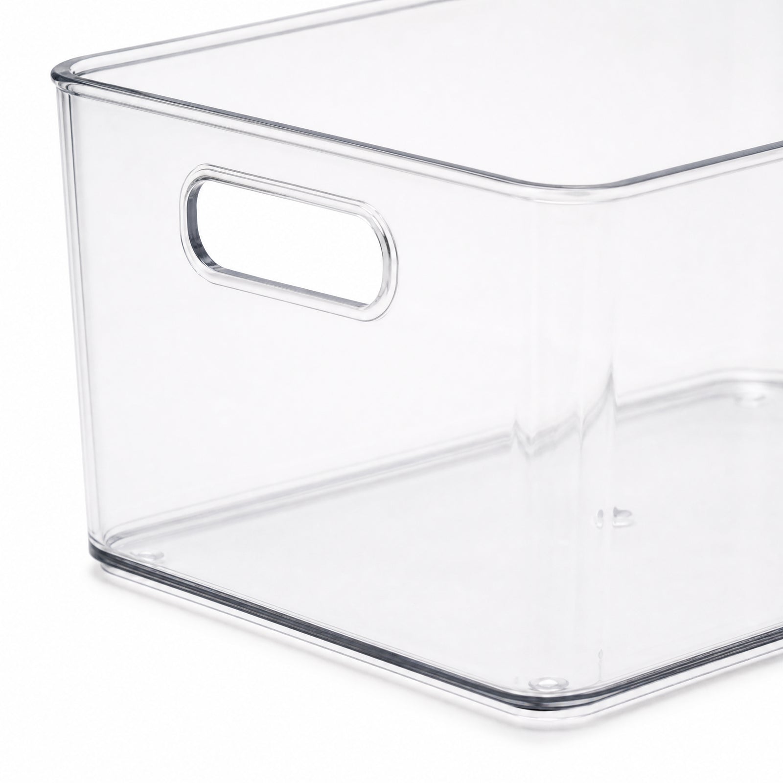 Close view of the clear storage bin handle rim and base edge