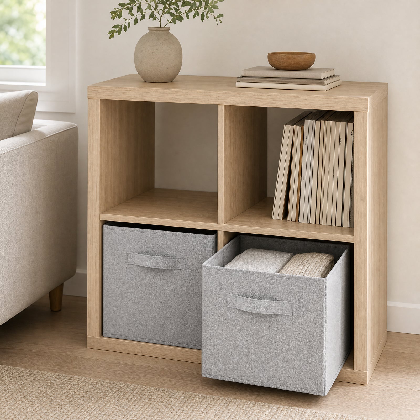Two light-grey storage cubes shown in pale-wood cube shelving